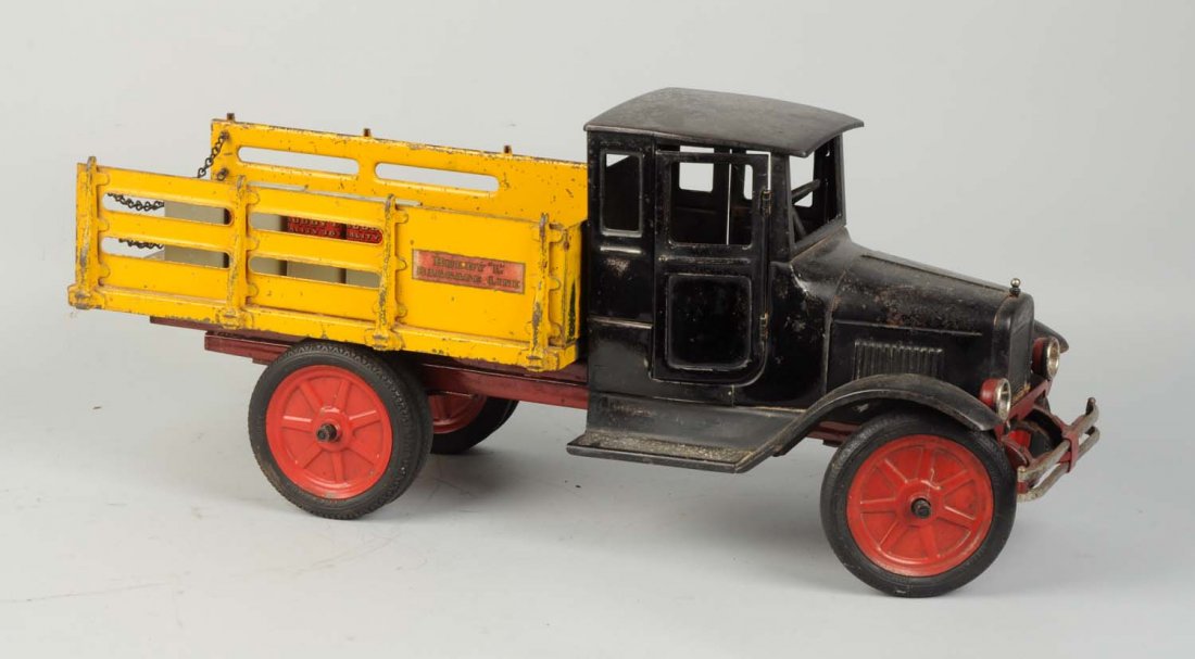Pressed Steel Buddy L Baggage Line Truck.: Circa 1930-1932. 24” in length. Featuring dual headlights, front bumper, and dual rear wheel rubber tires. Full box cab with opening doors. Overall heavy play wear, but very original. Includes four 