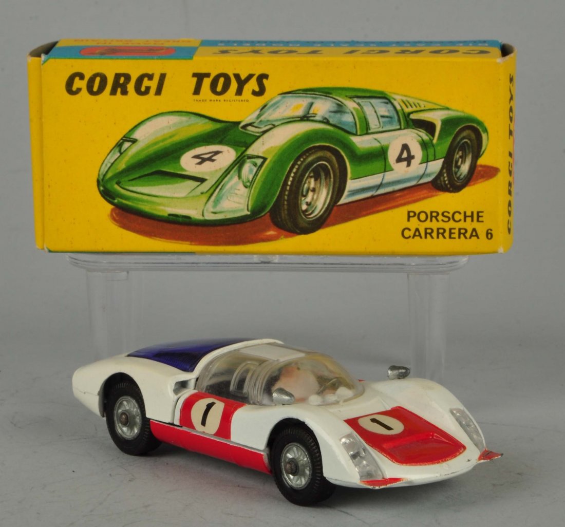 Corgi #330 Porsche Carrera 6.: One of the red rhinestone tail lights is missing. Otherwise this toy is in mint condition. Box is good, crisp and clean. Size 4" L.