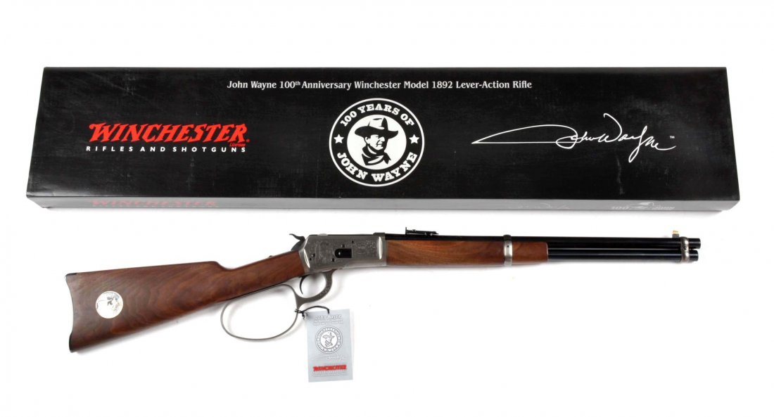 MIB Winchester John Wayne High Grade Carbine (M): Serial # JW100H0891 Made in Japan. Caliber .44-40. Carbine features an 18-1/2" barrel, full magazine, post front sight, folding ladder carbine rear, oil finished walnut stock, carbine metal buttplate,