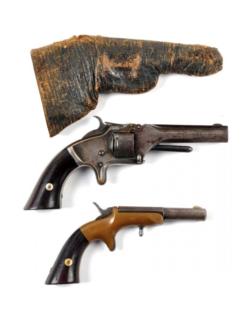 Lot of 2: Antique Handguns (A).: Serial # 74954 & NSV Item one is a Smith & Wesson tip up revolver Model No. 1 manufactured from 1857 to 1860. In .22 short rimfire caliber, seven shot spur trigger, single action with a 3-3/16" octago