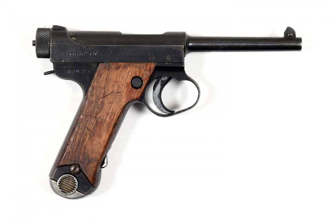 Japanese Nambu Semi-Automatic Pistol (C).: Serial # 68275 4-1/2" barrel in 8mm caliber. This is a Type 14 large trigger guard example with standard blued finish and walnut grips. The grips on this example are the smooth non-grooved variety. A 
