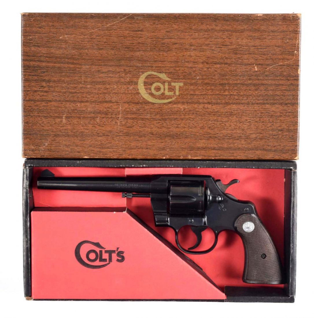 Boxed Colt Official Police D.A. Revolver (M).: Serial # 914611 6" barrel in .38 Special caliber. Manufactured 1967. Features include blued finish, six shot, double action, with silver medallion checkered walnut grips. This revolver is in excellent