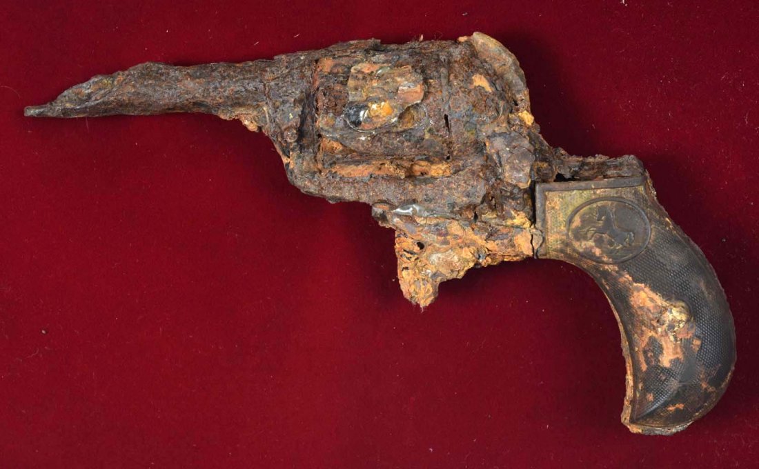 Colt 1877 Lightning Revolver Dug Up Loaded (A).: Interesting dug up Colt Model 1877 Lightning that was dropped in a hurry 100 years ago. When examining this revolver, it is evident that there are some empty chambers, as well as one visible chamber t