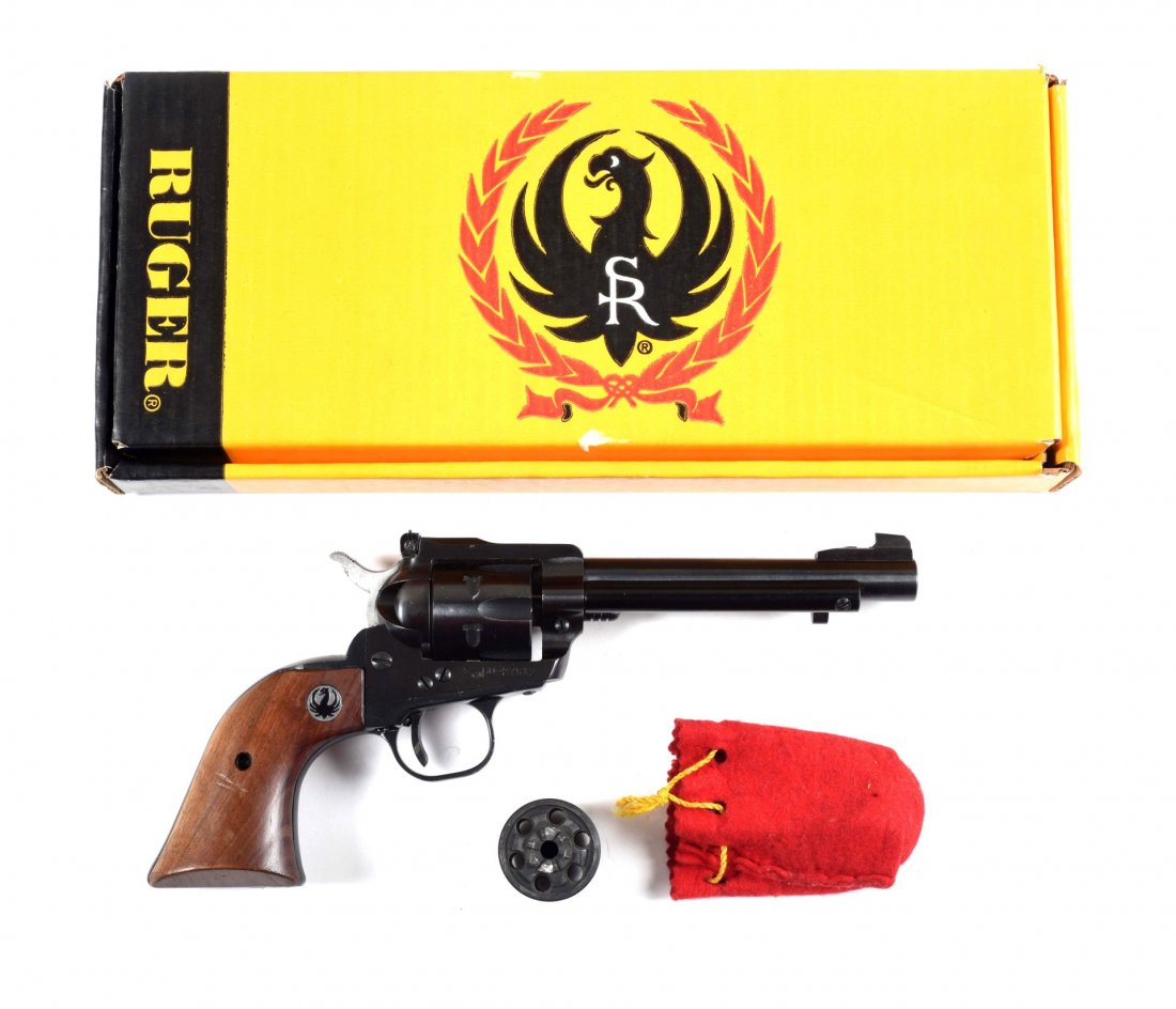 Ruger Single Six .22 Revolver (M).: Serial # 6027512 5-1/2" barrel in .22 rimfire caliber. Manufactured in 1970. This is a standard blued six shot single action with adjustable rear sight and walnut grips. 98-99% original blue. Fine bor