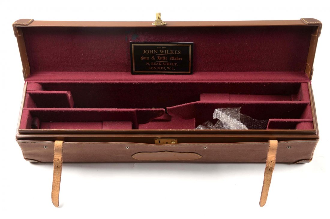 Fine English Leather Shotgun Trunk Case: Offered is a fine, high quality, English leather hard case lined in red velvet. Leather case takes a single shotgun. It comes with a two piece ebony cleaning rod and two John Wilkes London 16 bore sna