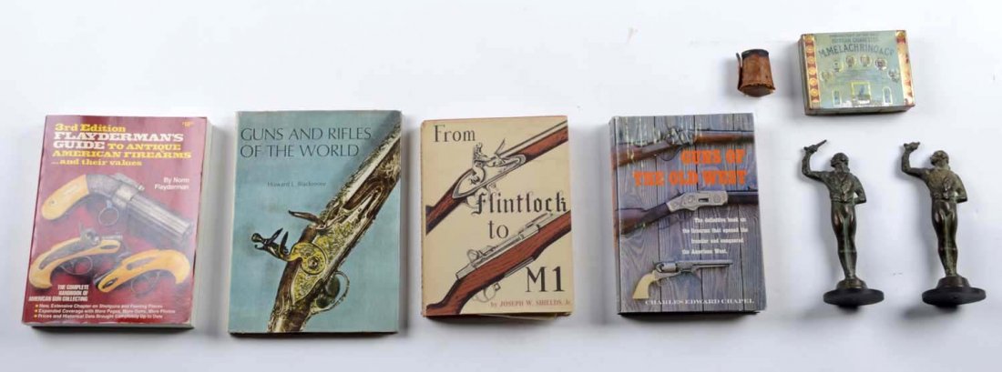 Lot of 8: Gun Potpourri: This Lot consists of two bronze book end / statues that measure 9" tall of Colonial Duelers. One pistol is broken. A set of 5 German stacking shot glasses. 5 military badges. And 4 books on firearms S