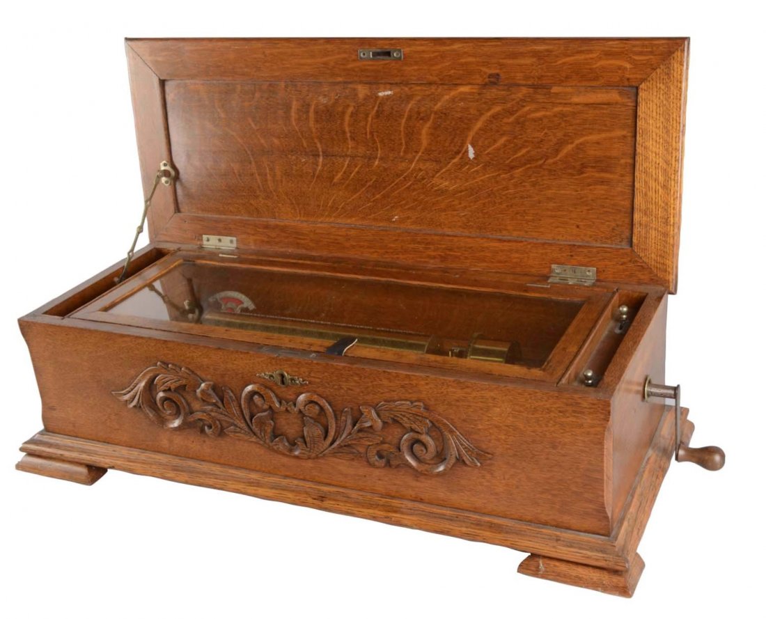 Quarter Sawn Oak Music Box: Nice oak cabinet features a decorative front design and fancy escutcheon with a side hand crank. Condition (Excellent). Size 29" x 12-1/2" x 8"
