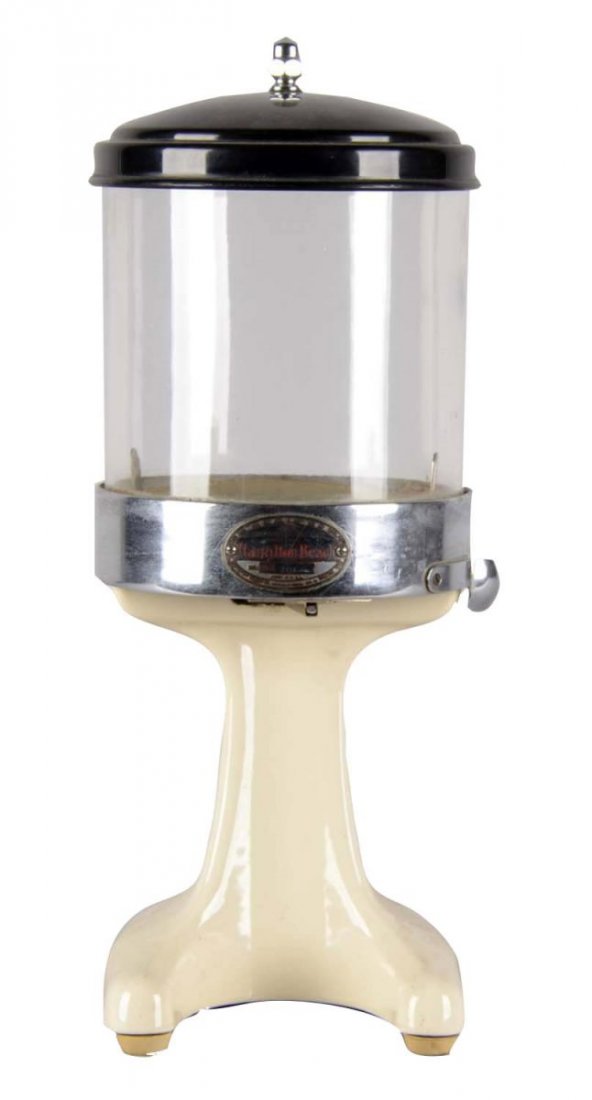 Hamilton Beach Soda Fountain Malted Milk Dispenser: This countertop malted milk dispenser has a beige, enameled steel base with a cylindrical glass hopper. It is a Model No. 20 D with a Serial No. of 2718. Condition (Very Good). Size 18" T. x 7-1/2" W.