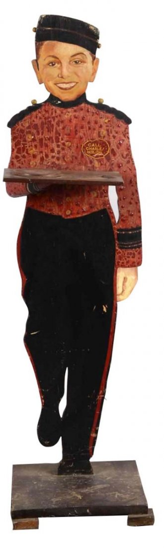 Wood Charles Hobson Smoking Stand: This die cut smoking stand features a smiling bellhop holding a tray in one hand. The boy's badge reads "Call Charles Hobson". While the display piece is structurally sound, much of the red paint of t