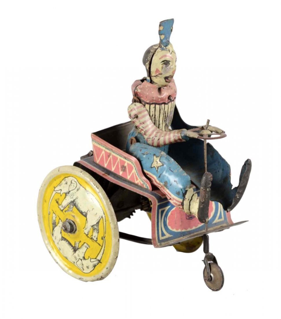 G&K German Tin Litho Clown Windup Toy: This clown is riding a cart with two oversized wheels featuring two elephants. Made in Germany and marked 504. Shows fading and paint loss throughout. Greppert & Kelch Clown on Circus Cart, circa 1920