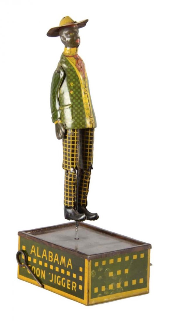 Strauss Tombo Alabama Coon Jigger Tin Windup Toy: This tin litho Black Americana windup toy features an African American man dancing on a wood grain platform. Pat. May 2, 1910. In working condition. Figure shows slight wear to clothing where his limb