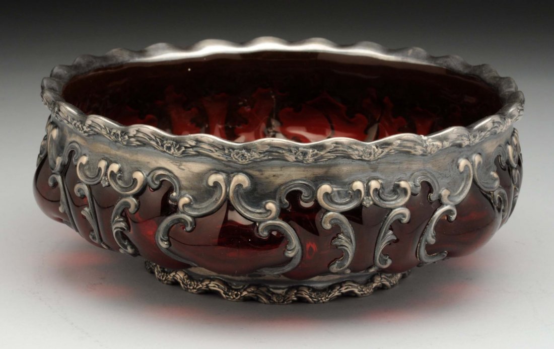 Whiting Sterling and Blown Glass Bowl.: Circular, the ruby red glass blown into a pierced scrolled framework. Foot damage. Size 8 - 1/2" Dia.