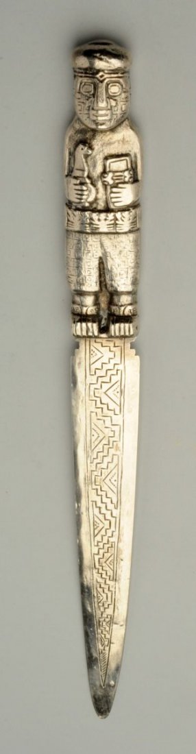 Silver Letter Opener.: With a chased figural handle and geometric engraving on the pointed triangular blade. Weight: 3.4 ozt. Size 11" L.