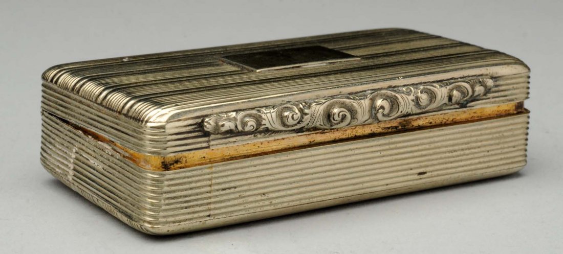 Silver Snuff Box.: 19th century, rectangular with grooved chasing and a chased thumb piece, the interior gilt. Size 2 - 3/4" L.