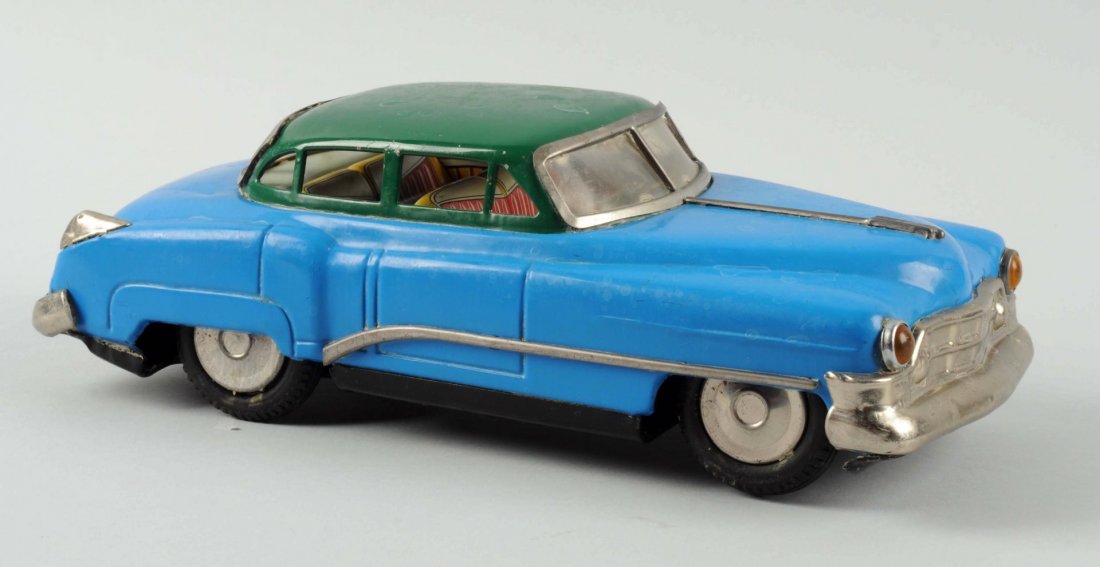 Japanese Tin Litho Friction Cadillac Toy.: Fat type body style. Made by T.N. Japan. All original parts. Some oxidation to bare metal parts. Needs to be cleaned which may make it a better grade. Condition (Very Good). Size 13" L.