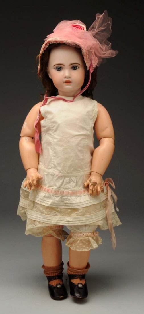 French 1907 Jumeau Bébé Doll.: Lovely incised bisque socket head with long dark multistroked eyebrows and inset threaded blue glass eyes with molded upper eyelids and painted lashes, closed mouth with generous upper lip and 6 upper
