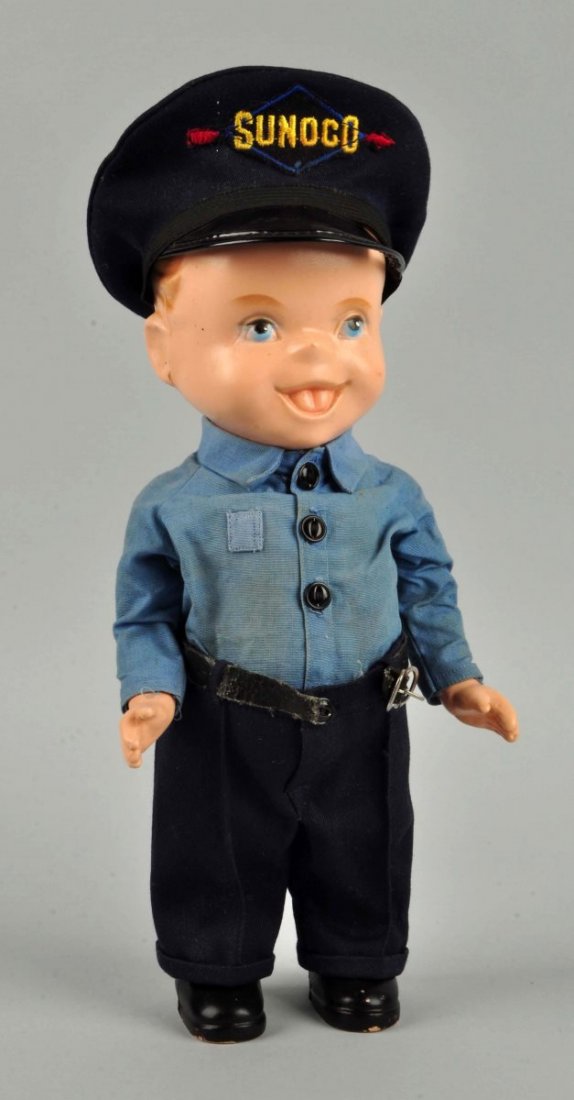 Sunoco Advertising Doll.: Hard plastic boy with molded blonde hair, painted blue eyes, and open/closed mouth with molded tongue, jointed shoulders, jointed arms, stiff hips, and molded black boots. Wearing light blue cotton sh