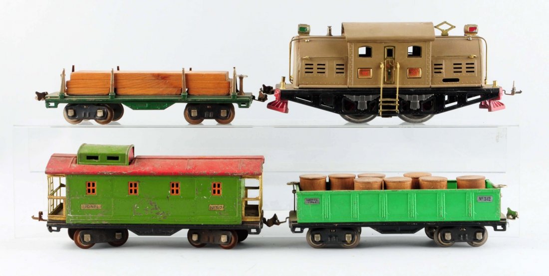 Lot Of 4: Lionel 380E Locomotive & Freight Cars.: No. 380E Locomotive, mojave, restored and re-wheeled. No. 511 Flat Car with lumber load, corrosion on the coupler and is missing one break wheel. No. 512 Gondola with barrel load, complete and all ori