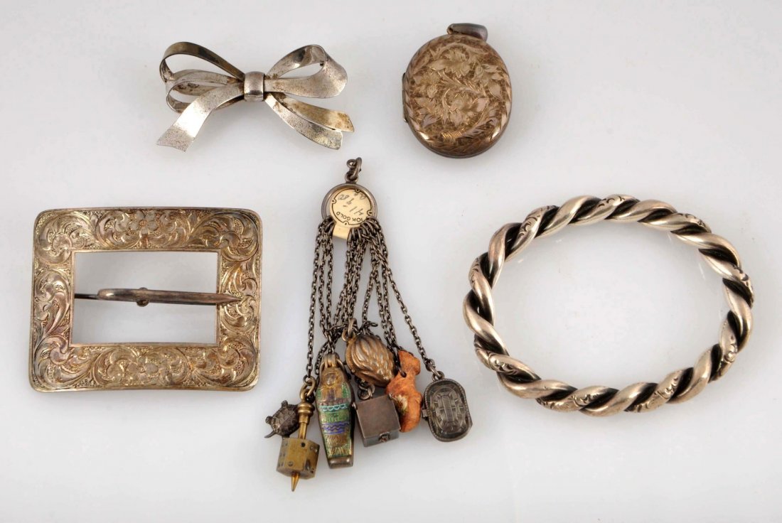 Lot Of 5: Early Silver Jewelry.: Including bangle; chase decorated buckle; locket; bow pin; and chatelaine charms on chains, 3.21ozt. Condition (Good).
