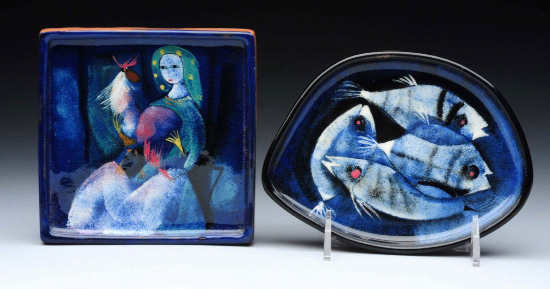 Lot Of 2: Pillin Trays.: Square tray shows a woman holding a chicken. The oval tree has geometric shaped fish for a design and measures 6 ¾” across. Condition (Excellent). Size Largest : 7" L.