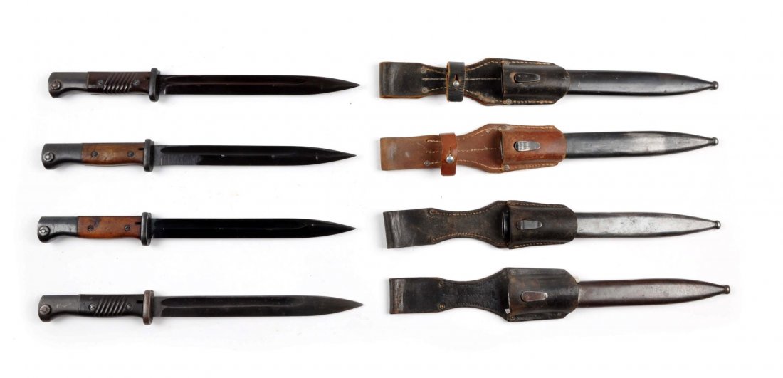 Lot of 4: German K98 Bayonets.: Four German bayonets for the 98 Mauser. All four have metal scabbards and leather frogs. Two have smooth wood scales, one has serrated wood scales, and the last has serrated brown composite. Condition