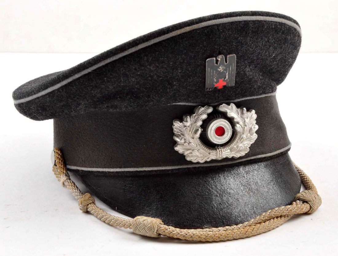 German Red Cross Officers Visor Hat.: Maker marked. ID'ed to Franz Wagner. Very good leather sweat band. Pliable black bill, dark grey body, light grey piping, metal eagle swastika red cross emblem, silver braid. Condition (Excellent).