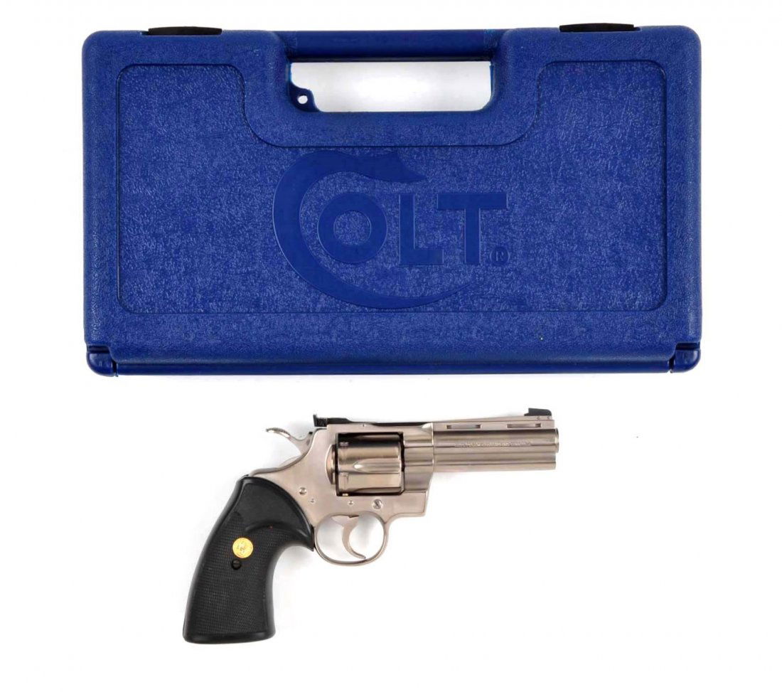 (M) Cased Colt Python S.S. Double Action Revolver: Serial # V60248 Caliber .357 magnum, Barrel length 4". Stainless steel model was manufactured 1983-1996. This revolver sports the Colt Pachmayr gold medallion and presentation rubber grips. It is a si