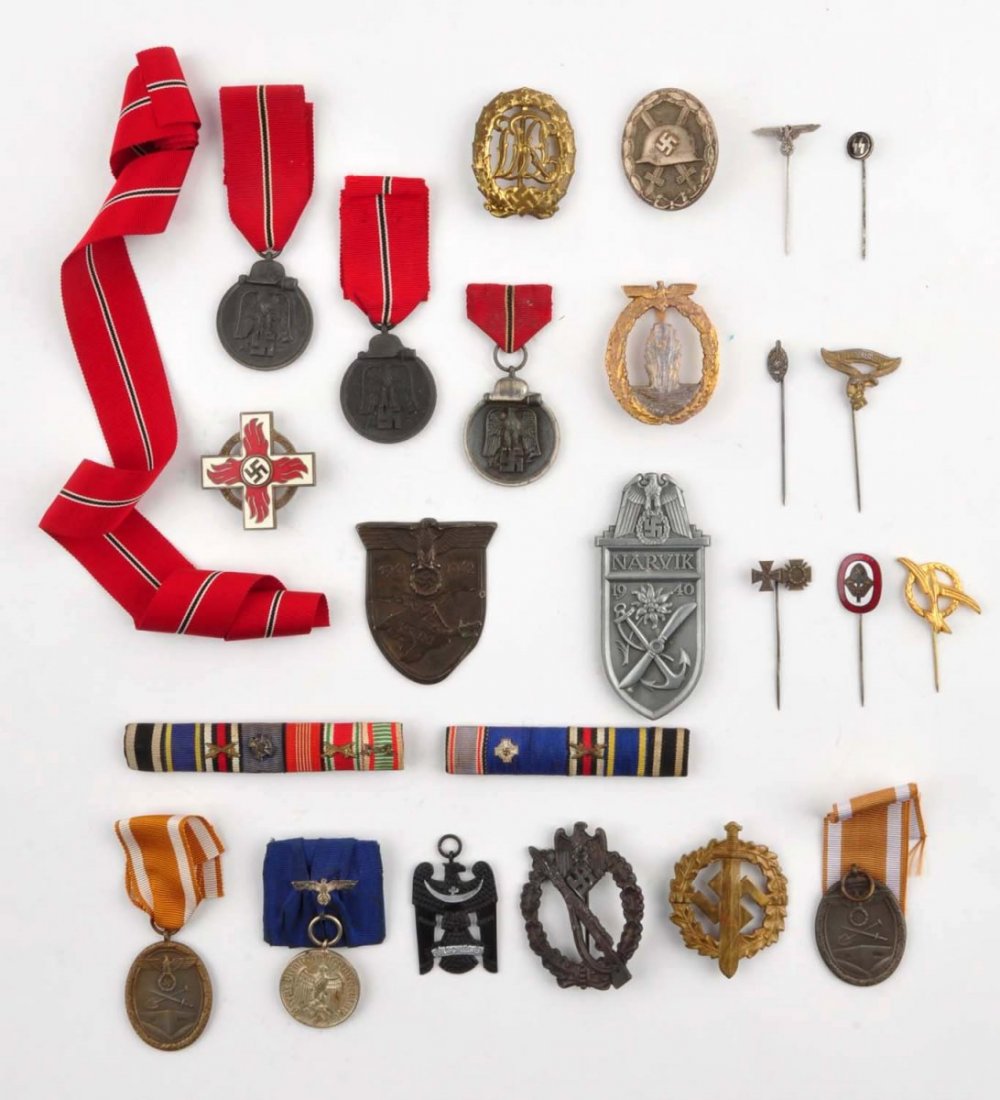 Large Lot of German Medals.: This lot of German Nazi medals consists of six medals with ribbons, two cloth uniform bars with pins, a hat badge, a medal with no ribbon, seven large pins, and seven small stick pins. Condition (Very