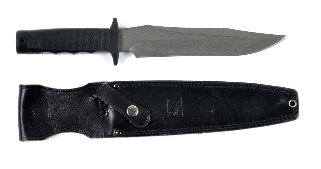 SOG Fixed Blade Bowie Style Knife.: SOG Seki-Japan Bowie knife. Saber ground clip point blade measures 8-3/4" with an overall of 14". Checkered hard rubber handle. Correct black leather sheath signed SOG specialty knives. Contemporary. 