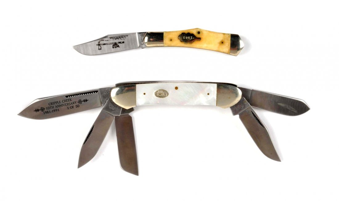 Lot of 2: Pocket Knives.: Cripple Creek U.S.A. (Cargill), circa 1983, 3-1/4" 1-blade "Eureka" jack knife with a flat oak leaf shield containing the date of 1983. Scales are smooth white bone. Blade etched with a pipe and tomah