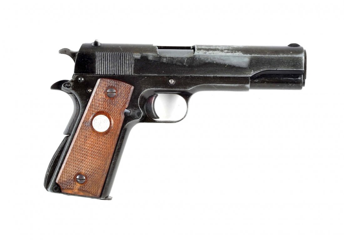 Colt Copy Model 1911 A1 Pistol.: Model 1911 A1 replica of an Army Model shoots .45 blanks. Has a rough military style finish. Walnut grips with silver medallion. Finish loss on slide and frame, remains at about 40%. All working parts
