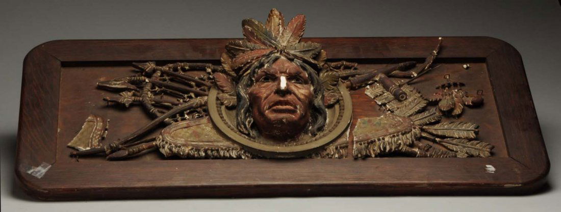 Carved Indian Wall Plaque.: The plaque appears to be made of a composite material and is framed with wood. Numerous cracking and loss to some of the front design. Condition (Good). Size 40 - 1/2" x 17 - 1/2".