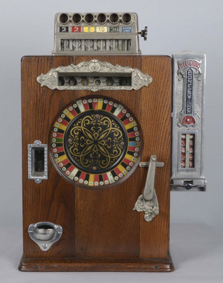 5¢ Watling Brownie Counter Wheel Slot Machine: A latter “one wheeler” counter top payout machine with the unusual feature of a side vendor. Circa 1920s, this machine had the typical payout of the earlier color wheels yet its cabinet and visual
