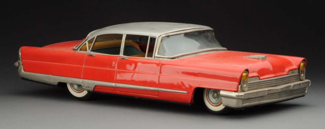 Japanese Tin Litho 1964 Lincoln 4-Door Sedan.: Friction powered. Finished in red and silver with white wall tires. Striped interior. Nice sized car. Very difficult to find. Does have scratching and wear on the bottom of the car. Some minor spideri