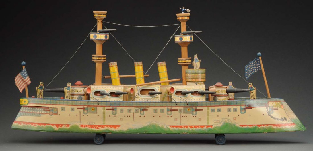 Early American Made Paper on Wood Battleship Toy.: Late 19th century. Unmarked but probably Bliss or Reed. Ramrod prow, three tall stacks, twin masts with six lookouts and gun stations. Swivel guns. Simulated ocean waves at the base. Deluxe model. Doe
