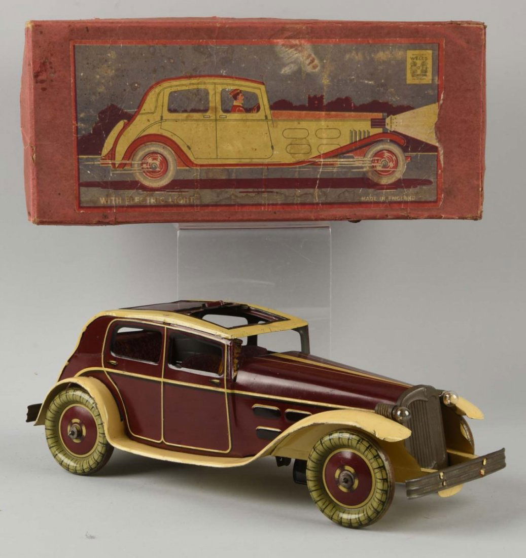 English Wells Tin Litho Wind-Up Automobile Toy.: Comes with difficult to find original box with nice color label of car on front. Marked "Wells" and also marked "Made in England". Batter-operated headlights. Tin litho sunroof. Nice original tin lith