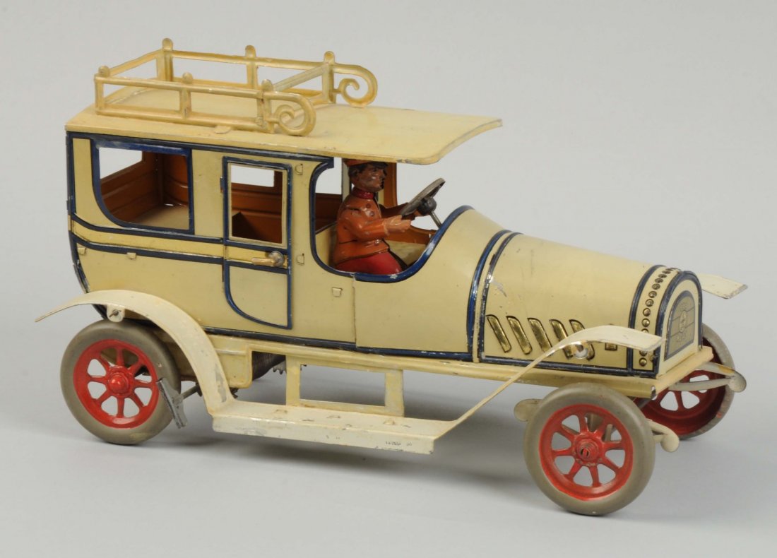 German Tin Litho Clockwork Hans Eberl Limousine.: Includes original full dimensional lithograph driver. Has "Ebo" mark on front grill with the same on the rear. Also marked "DRGM Made in Germany". Very ornate roof rack. Has adjustable steering and op