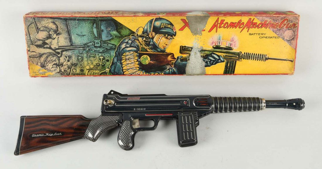 Japanese Tin Litho Battery-Op. Atomic Machine Gun.: Includes colorful original box showing astronaut firing machine gun. Box has some restoration on one side apron, some paper loss, and creasing. Gun is marked "Atomic Ray Gun" on rear stock and "S-No.