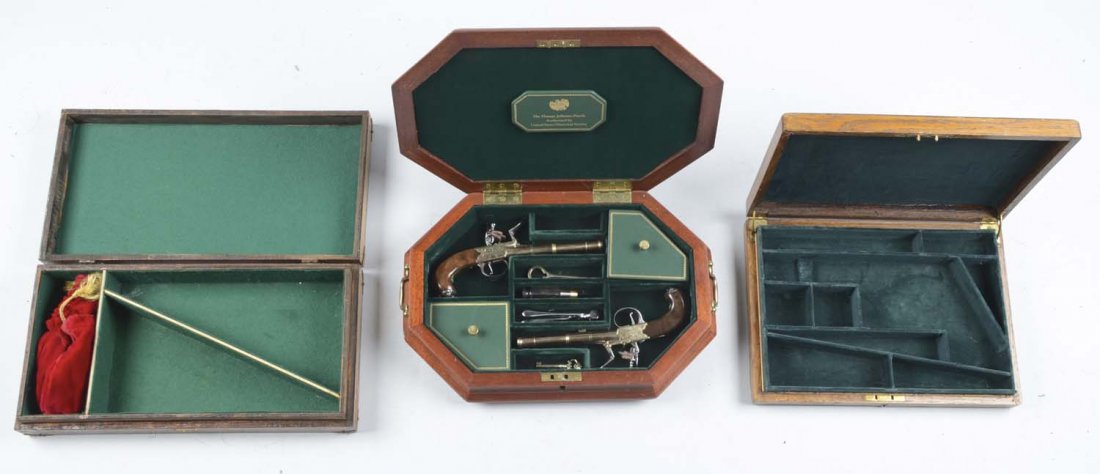Lot of 3: (A) Thomas Jefferson Pistols and Cases.: Serial # 631A, 631B An octagonal shaped cased pair of Thomas Jefferson reproduction box-lock pistols by U.S. Historical Society. Set includes two single-shot boxed flintlock pistols plus accessories,