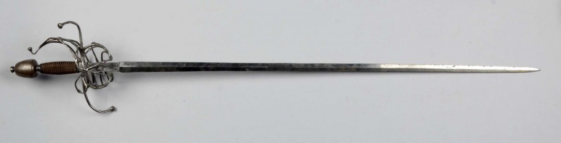 Continental Swept-Hilt Rapier.: Having an unadorned 36" tapered blade of diamond section. Swept hilt with small branch construction and recurved quillions. Orb-shaped pommel. Wire-wrapped grip. Blade showing wear, pitting and polish