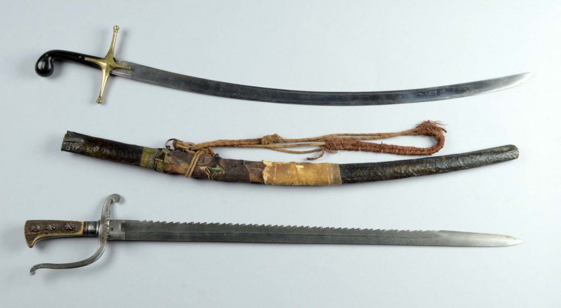 Lot of 2: Eastern Shamir & Saw Back Pattern Sabre.: Comprised of: 1) Saw back pattern sabre has a 29- 3/4” straight blade with one fuller. Proof mark looks to be a crown. Iron hilt with shell cross guard with bone or horn grip. 2) Eastern Shamir has