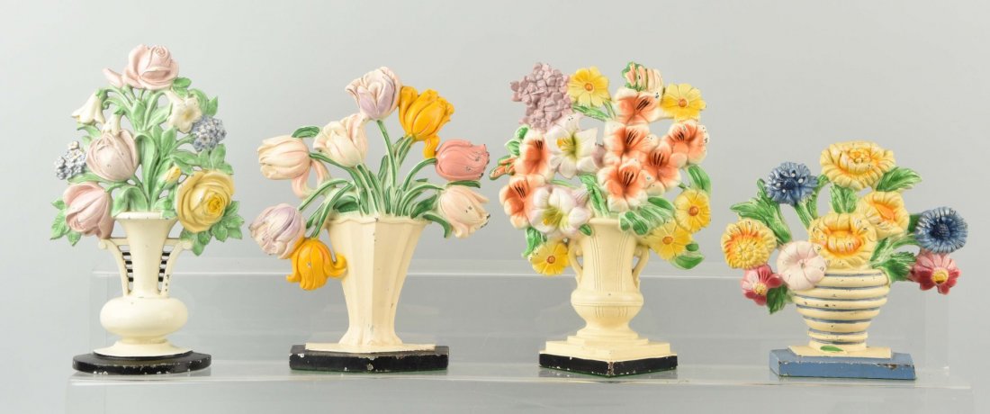 Lot of 4: Cast Iron Assorted Flower Doorstops. (1 of 1)