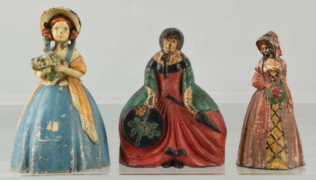 Lot of 3: Cast Iron Assorted Lady Doorstops. (1 of 1)