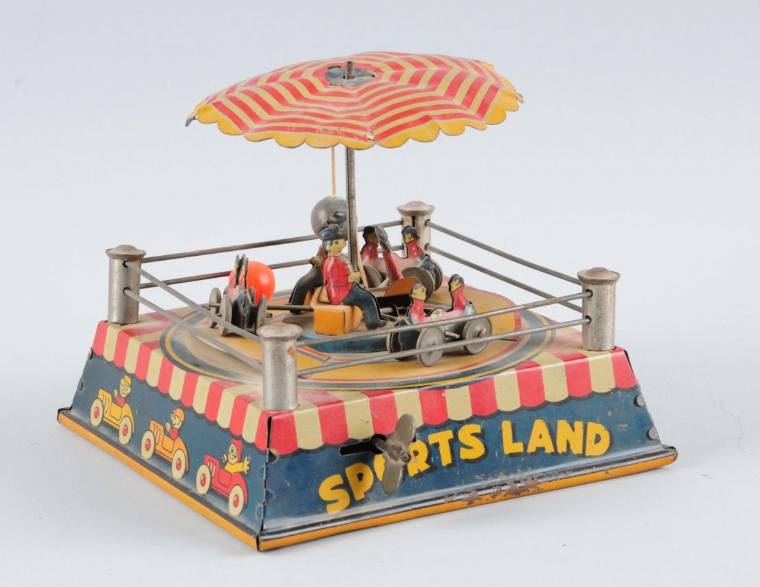 Sports Land Tin Litho Wind Up Toy.: Three racers. Appears complete. Pre-War Japanese. Condition (Very Good - Excellent). Size 6-1/4'' x 6-1/4''.