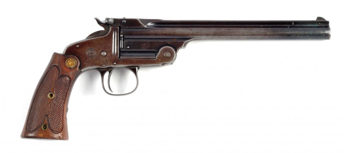 (A) S&W Single Shot Target Pistol.: Serial # 21410 Caliber is .22 long rifle, barrel length is 8". Features full length ribbed barrel with no cylinder, top break action, blued finish with gold medallion checkered two screw walnut grips.