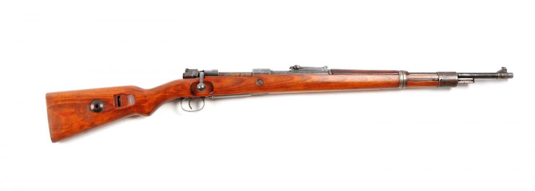 (C) Nazi Marked Mauser Model 98K Carbine.: Serial # 749 24" barrel in 7.92x57mm caliber. Standard arm of Germany in World War II. "ce" code on chamber (Sauer & Sohn) and "43" year code on rear bridge. Laminated stock is excellent with no stamp