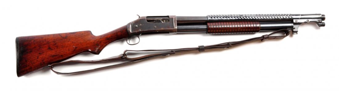 (C) Winchester Model 1897 Trench Gun.: Serial # E732353 20" barrel in 12 bore. This shotgun was manufactured in 1924. It was manufactured as a standard civilian 20" barrel, cylinder choke riot gun. Sometime during its life a trench handgua