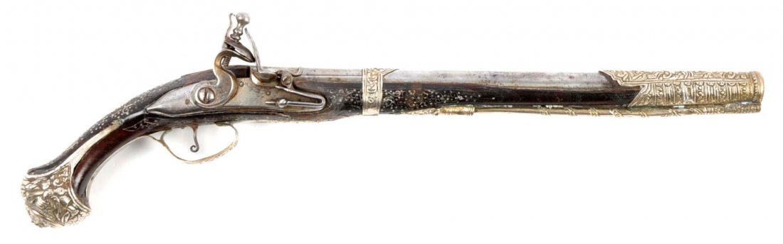 (A) Silver Mounted Ottoman Flintlock Pistol.: Serial # NSN Tapered 14-1/2” round barrel with chiseled rib on top in .66 caliber smoothbore. Barrel fastened by silver band on forend engraved with relief florals and large silver band around muzzl