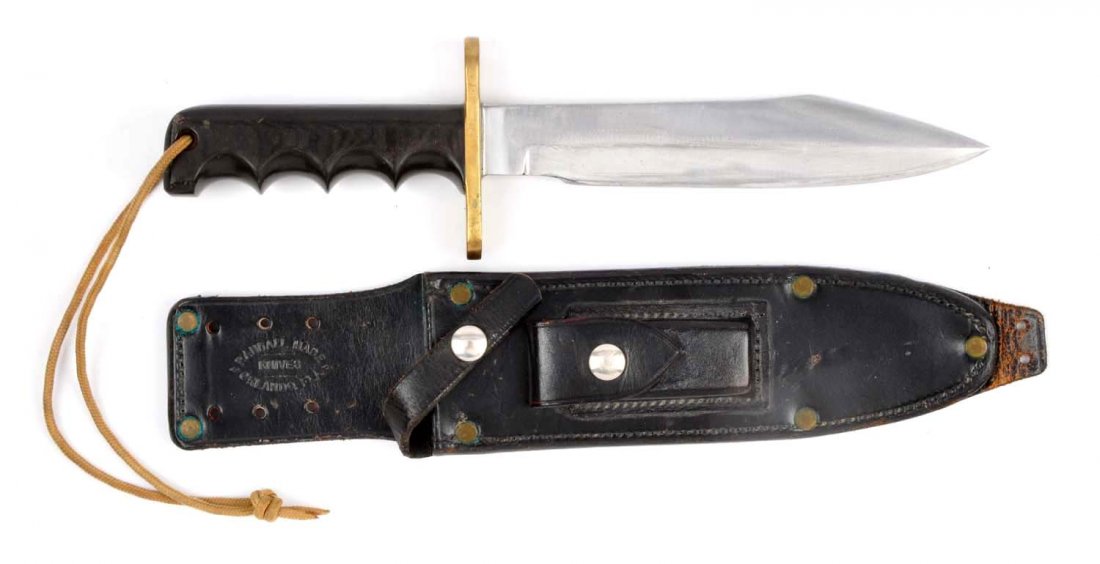 Randall Made Solingen S Model 14.: Saber ground clip point measures 7-1/2'' with an overall of 12''. Finger notched black micarta handle with lanyard hole and brass oval guard. Correct sheath with sharpening stone. Condition (Very Good