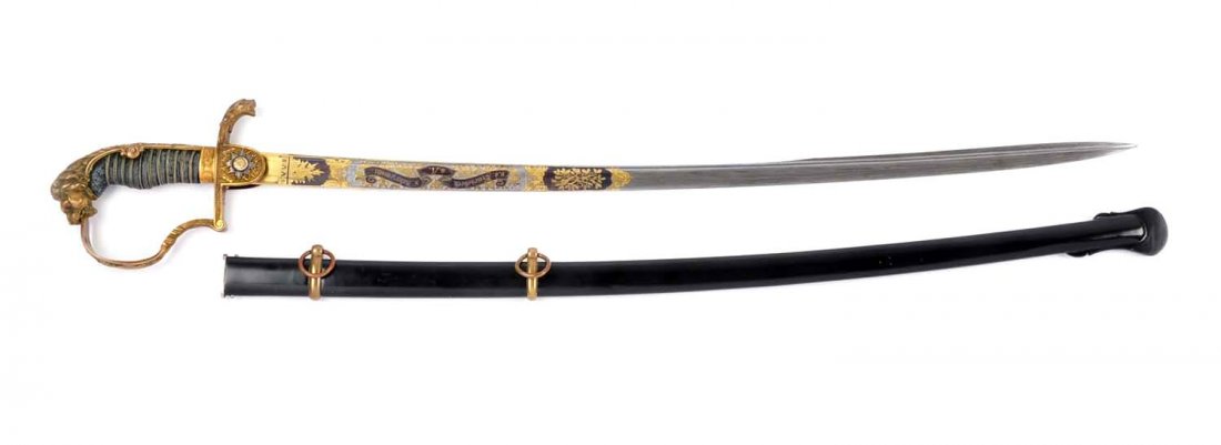 Imperial German Lion Hilt Officer's Sword.: 38" overall length . Damascus quill blade. Inscribed to officer with date, 1896/97. Perfect shark skin wire wrapped grip. Lion head pommel with ruby eyes. Crest on langet. Perfect blued scabbard. Over